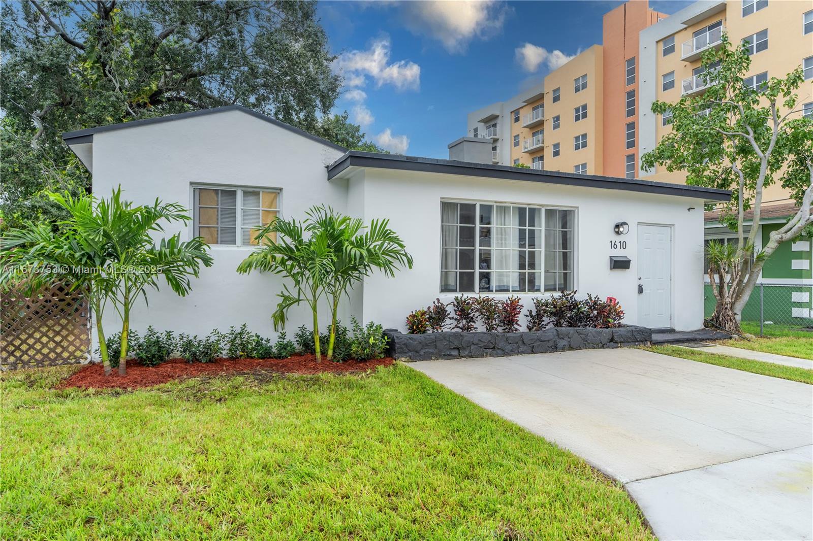 Welcome to 1610 NW 53rd, an exceptionally spacious 4-bedroom, 3 FULL bath home boasting over 2,000 sq ft—the largest in the neighborhood. Thoughtfully expanded to include two primary bedrooms with en-suite baths—one at the front and one at the back—the layout offers flexibility for various living arrangements. Fully reimagined in 2019 with a new roof, HVAC, windows, plumbing, and a modern kitchen, this move-in-ready home features an inviting open-concept design. The kitchen boasts stainless steel appliances and a chic grand island flowing into the dining room. The expansive living area provides generous space rarely found at this price point. Located in an X flood zone, this home has never experienced flooding. Situated minutes from downtown Miami, Wynwood, and the Design District.
