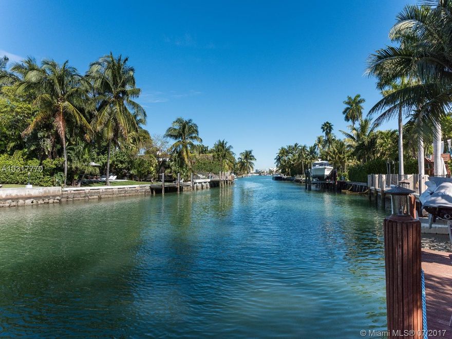 Perfectly located Classic Architectural Masterpiece on a lush tropical & serene setting. Near Lincoln Rd & Sunset Harbour shops. 6,204 sf home, 4 bed upstairs each w/its own bathroom. Large master suite w/front & rear terraces. Additional Open loft area w/its own separate room & bathroom. 100ft of waterfrontage.Large dock, covered outdoor terraces, & pool. 3 car garage & private courtyards. Home is very well maintained & tastefully renovated including impact windows & doors. Ready to move in