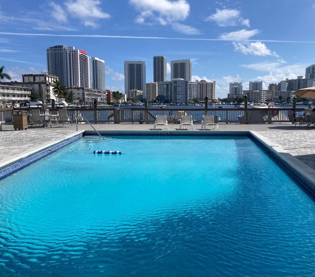 Photo of 462 Golden Isles Dr #206, Hallandale Beach, FL 33009 (MLS # A11965613)