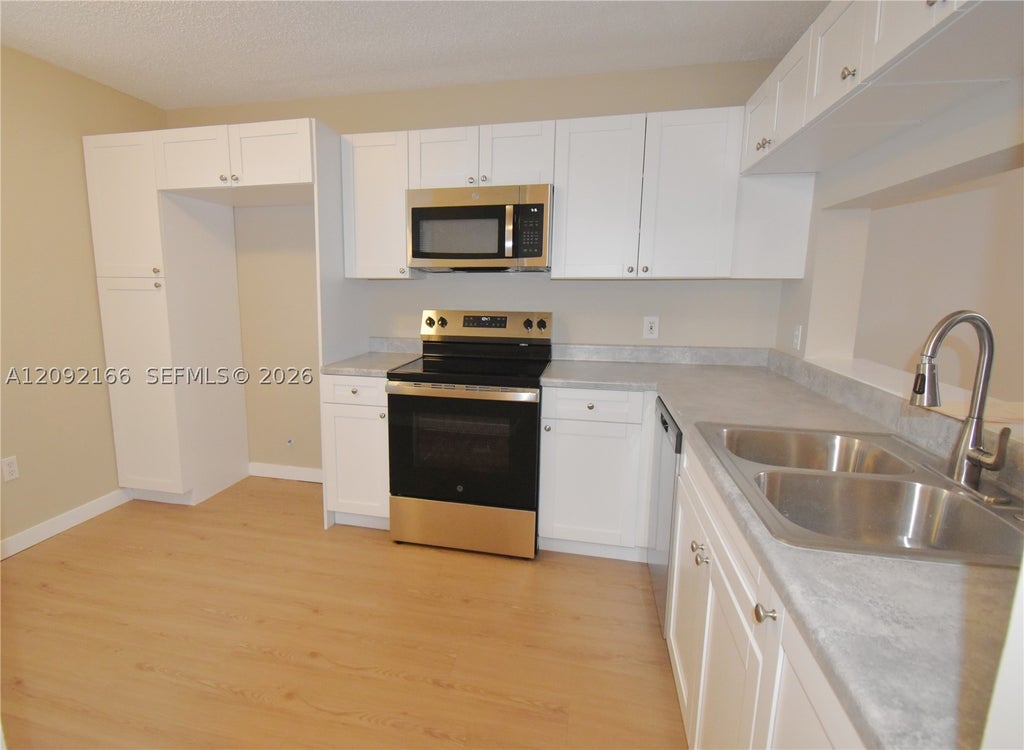 Photo of 10360 NW 30th Ct #405, Sunrise, FL 33322 (MLS # A12092166)