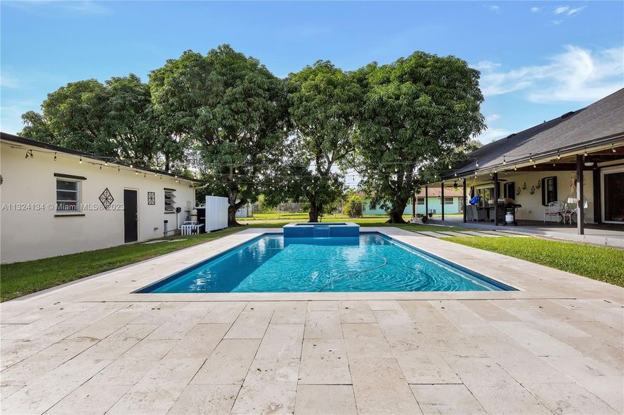 Welcome to your new home! This incredible property features 4 bedrooms, each with walk-in closets, 3.5 bathrooms (2 of which are in-suite baths), and has many fantastic upgrades. Whether you want to take a swim in your beautiful pool or relax in your Jacuzzi (completed in 2018), this home has exactly what you need! Enjoy the peace of mind that comes with newer roofs for both main home and oversized garage (roofs completed in 2019), as well as accordion shutters all around and hurricane-rated garage doors. No home upgrade is complete without new bathrooms(2021).  When in season, take advantage of the 16 fruit trees your property has to offer, like avocado, mango, lychee, and tamarind. This home is ready for it's next lucky family!