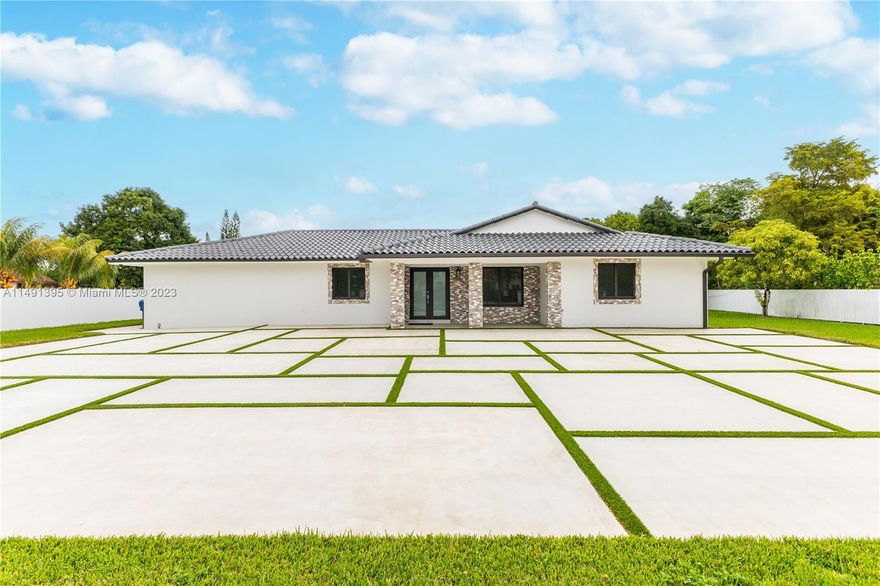 This stunning property has recently undergone a complete renovation and now stands as a true masterpiece.  Complete privacy and tranquility await you at this estate, which features a generously sized kitchen, office/den, ensuite master bathroom, a large swimming pool, and an additional structure containing two guest houses, each unit with 2/2.
There are a total of 8 beautiful bedrooms and 7 luxurious bathrooms. The estate is surrounded by tropical fruit trees and benefits from high-impact windows & doors, ensuring both security and serenity. Located on a spacious 1.09-acre lot in the highly desired Horse Country State, offering the option to add stables for those who love horses. Far from the noise of urban life an ideal sanctuary for large families seeking comfort, beauty, and peace.