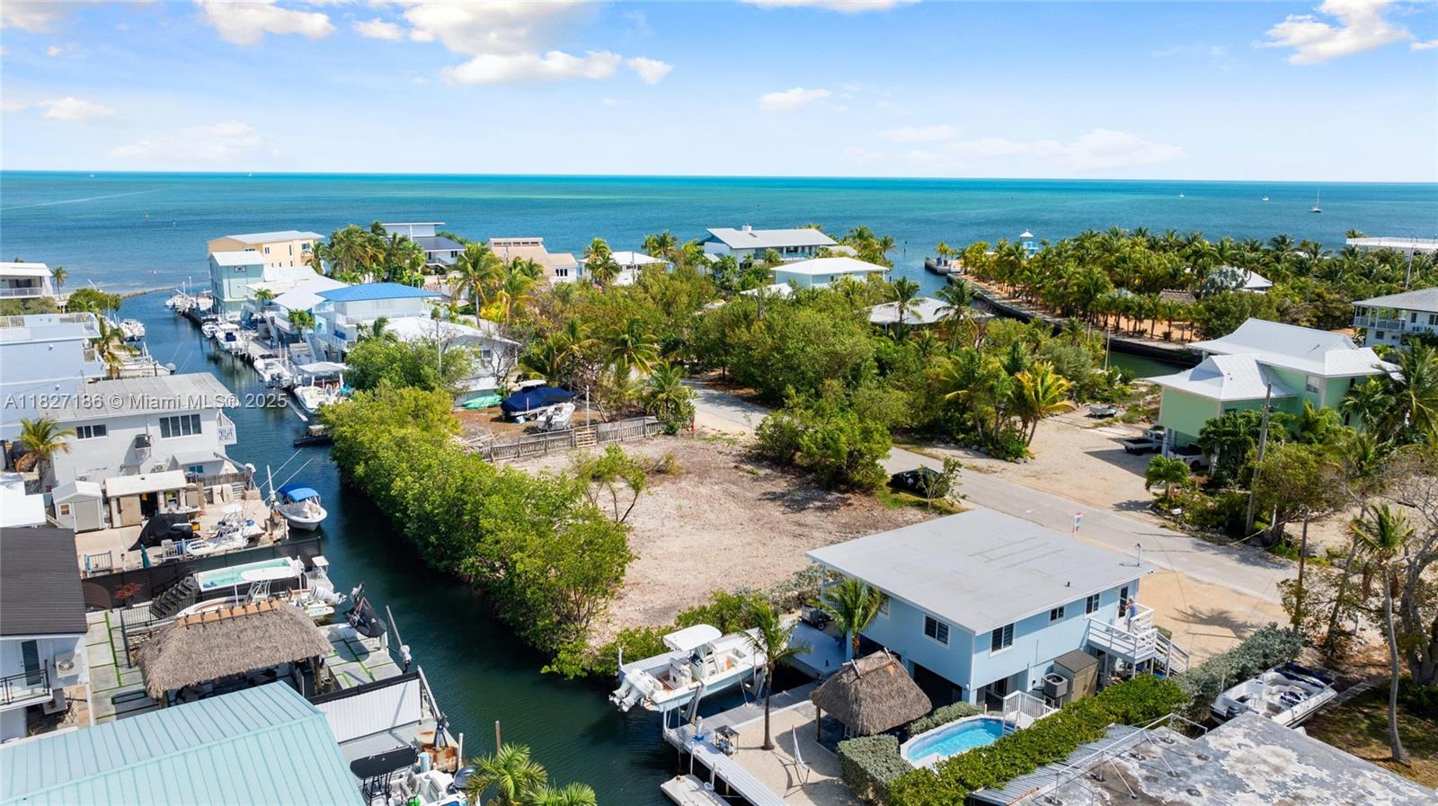 Waterfront living in the heart of Key Largo! This move-in-ready retreat offers 60’ of frontage, ocean access, boat slip with 10K lb lift, and a separate guest suite. Upstairs features 2 beds, 1 bath, an open layout, and a large porch overlooking the canal. Entertain under the tiki hut, grill out, and enjoy the ocean breeze. Located in a sought-after neighborhood with quick access to world-class fishing, diving, and all the best of the Florida Keys lifestyle.