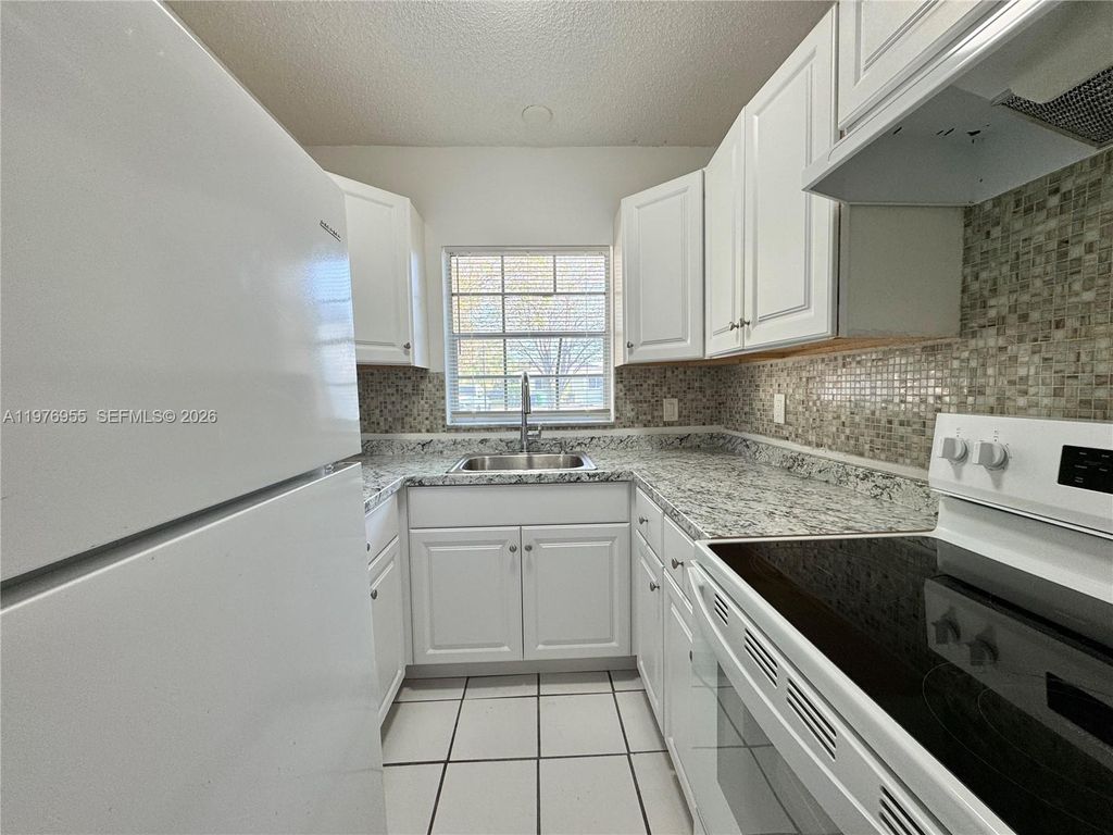 Photo of 4140 Woodside Dr #107, Coral Springs, FL 33065 (MLS # A11976955)