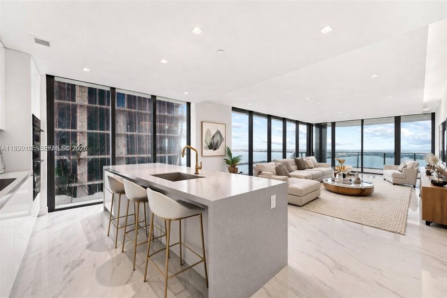 Spectacular high-floor residence at Aria Reserve South Tower, Line 01 (54th floor), featuring 4 bedrooms + office with direct Biscayne Bay and Ocean views. Fully upgraded with all developer options, including Arabescato porcelain floors, Cromat Gray terrace tile, custom ceilings with LED lighting, Somfy motorized shades, upgraded kitchen with Serena Matte countertops, custom illuminated closets, frameless shower glass, and matching bath accessories. Smart-home ready (Savant compatible). Enjoy world-class amenities: sunrise & sunset pools, spa, gym, tennis courts, dog park, kids area, lounge, and direct baywalk access in the heart of Edgewater. Walking distance to restaurants, shops, and minutes from Design District, Wynwood & Downtown Miami. A true masterpiece in the sky.