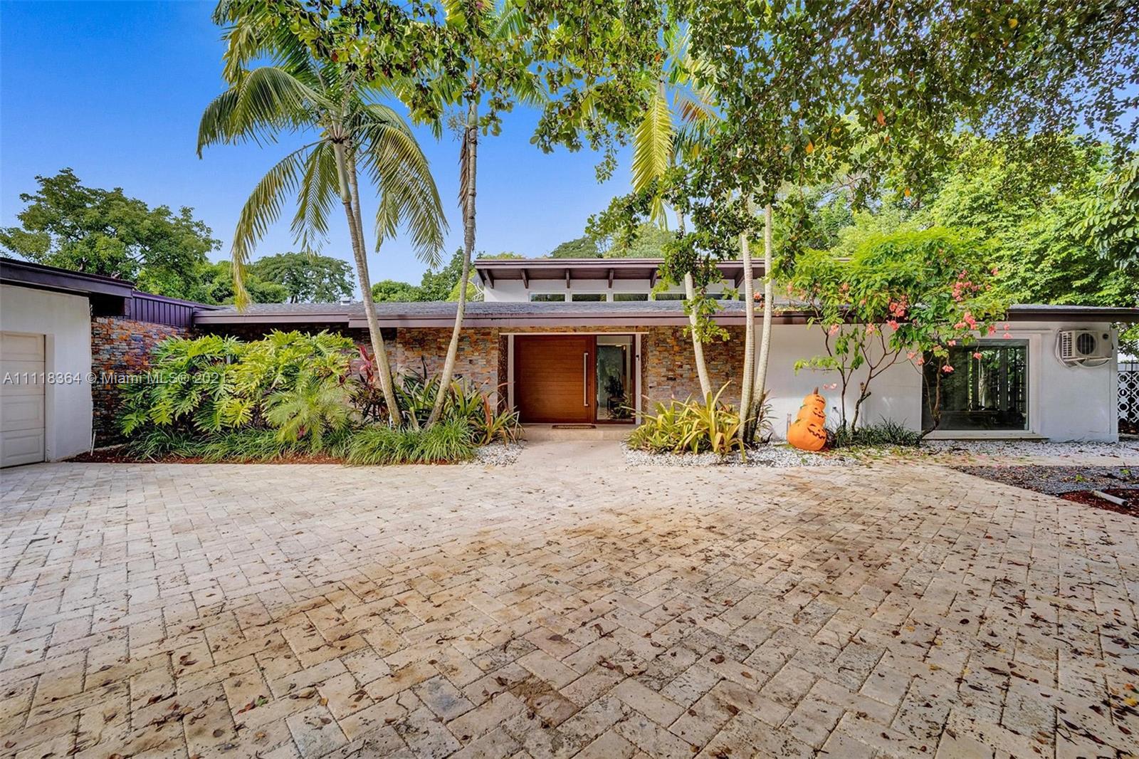 Nestled in a tropical oasis of lush landscaping and fruit tress, this one story home is very spacious, perfect for entertaining family and friends. The entrance foyer leads to the formal dining and living area which features vaulted ceilings and is surrounded with glass panels and sliding doors leading to the backyard. Grand and Gorgeous In Every Way! Large 27,260 SQ Ft Lot in the most Sought After Pinecrest Area. Close to the Best Schools in the Area, Shopping and Restaurants. Impact windows and doors, Wine and Cigar Temperature Controlled Cellar, Gourmet Kitchen, 2 Car Garage, 2 Master Suites, 2 Additional Spacious Bedrooms Plus a Separate Outdoor Bedroom and Bath That Can Be Used As a Housekeepers Quarters, large Pool with Summer Kitchen. This is the home you have been waiting for.