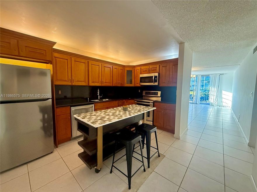 Bright and spacious 900 sq ft corner unit located on the second floor of a gated community in North Miami. This residence features a large bedroom with a walk-in closet and a versatile enclosed den, ideal for a home office or guest room. The unit offers an open kitchen, a combined living and dining area, tile flooring throughout, and hurricane shutters for added security.
One assigned parking space. Rent includes water, hot water, and waste. Laundry rooms are available on each floor. Conveniently located near Biscayne Blvd, the beaches, banks, shopping centers, restaurants, Aventura Mall, FIU, and Barry University.