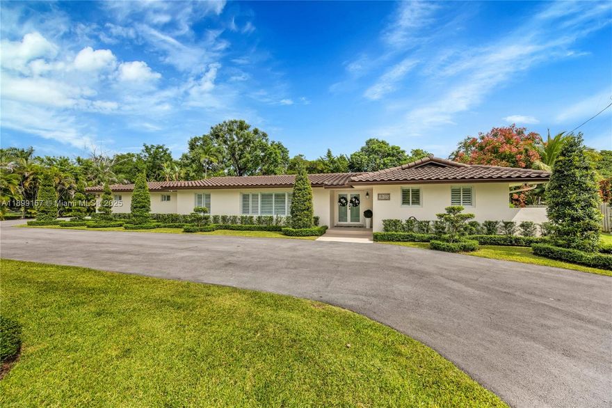 Nestled on over one acre of manicured grounds, this 5-bedroom, 4-bath home offers a rare blend of space, comfort, and resort-style amenities. Featuring a formal living, dining & family room w/ beautifully renovated kitchen and appliances. The primary suite features dual vanities & walk-in closets, while a private guest wing of living room, wet bar, and ensuite bedroom ensures ultimate privacy for visitors. Step outside to a large covered patio with bar overlooking the beautiful pool leading to the koi pond, fire-pit, tennis court, expansive lawn, and large storage shed. The home has an 8 yr roof and full impact rated doors & windows. Located in one of Miami’s most peaceful enclaves just moments from Palmer Trinity School, this estate offers the perfect balance of tranquility & elegance
