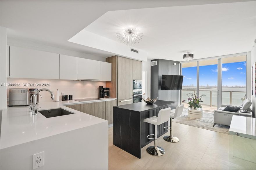 Refined 2-bedroom, 3-bathroom residence offering a private foyer and a thoughtfully curated design throughout. This fully furnished condo stands out for its sophisticated finishes and extensive upgrades.
The primary suite offers a comfortable and well-designed space with a custom walk-in closet, updated shower fixtures, and modern floating vanities. Italian porcelain flooring runs throughout the unit, creating a clean and contemporary feel. The kitchen features high-quality appliances, a black island, and electric blackout shades that provide both comfort and privacy.
The residence provides private elevator access and tranquil bay views. Balconies are currently enclosed; building management has indicated they are expected to reopen in February 2026.
Offered fully furnished, with the understanding that certain personal and decorative items shown in photos have been removed.
Residents enjoy an exceptional collection of amenities including two resort-style pools, a private beach club, fitness center, spa, tennis courts, and 24-hour lobby attended. One assigned parking space is included.
Located minutes from the Design District, Midtown, and the Kaseya Center, this residence offers an elevated Miami lifestyle with access to exclusive waterfront and wellness experiences.