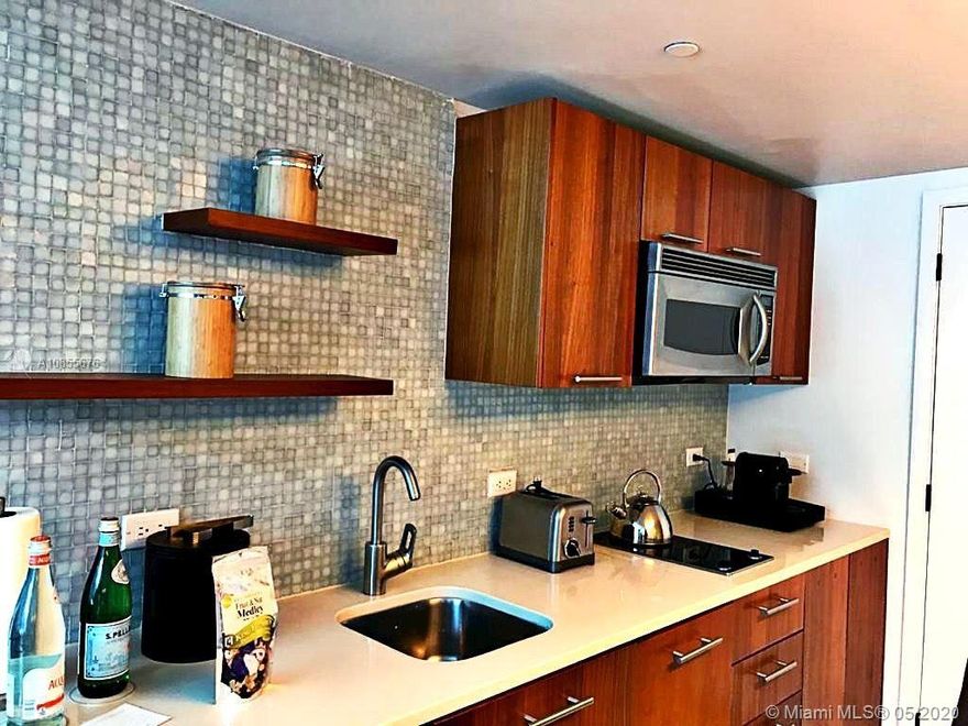 Carillon Miami Wellness Resort, with city, bay and sunset views. Option of participating in hotel rental program, or not. Owner may also keep for own use. Unit has always been in the hotel rental program; so, it has upgrades required by hotel and kept in the standards of the Carillon (and previously Canyon Ranch). Kitchen has 2 burner stove, microwave, refrigerator, washer, dryer, dishwasher. Large, spacious unit can be made unique for longer-term living. Classes 7days week, ALL included. Enjoy 70,000 sqft fitness spa center – to rejuvenate body an soul -- 4 pools, salon, concierge, restaurant, bar, 24hr security, valet, wellness staff, boardwalk. Great value for desired unit. Luxury and wellness combined an unparalleled lifestyle. Motivated Seller!