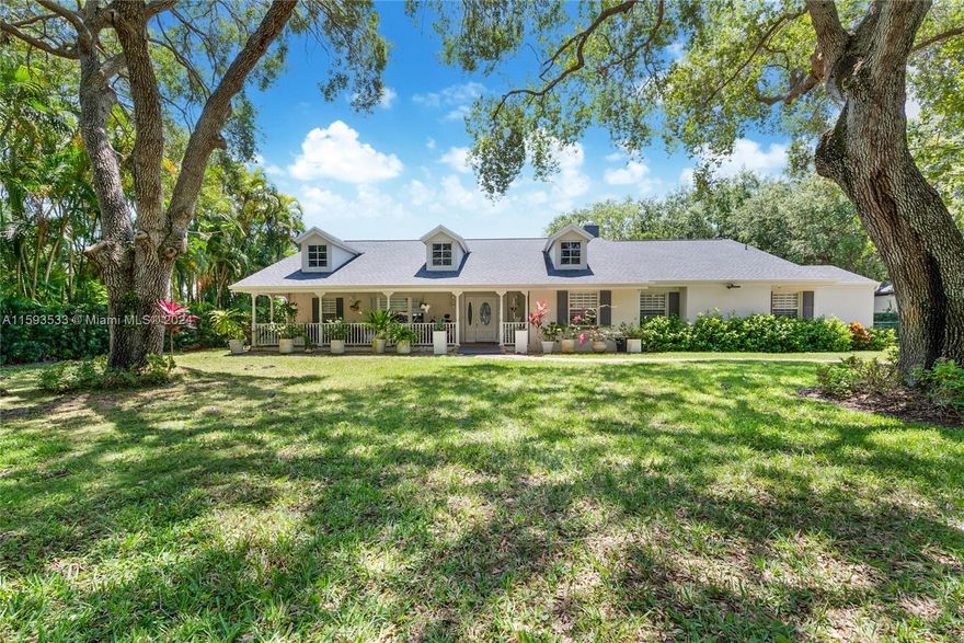 Premier location on a quiet street in North Pinecrest! 
Excellent land value to build your dream home or reimagine this charming New England style 5 BD/4BA with vaulted ceilings, wood floors and a sparkling pool.  Nestled in the backyard is a one bedroom, one bath cottage connected to a 2 car garage.  This expansive 40,075 SFT lot is graced with majestic oak trees, mature foliage and wide open spaces.  Impact Glass, New Roof, and Gated.