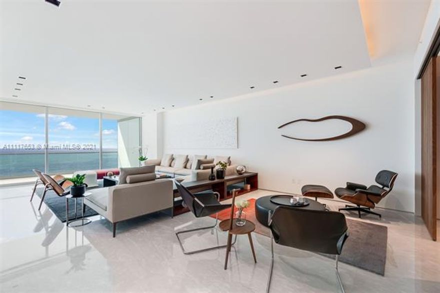 Upgraded flow-through beachfront residence with Ocean & Bay views. Spacious 3,264 SF floor plan & fantastic layout, private elevator, two oversized terraces, 10 foot ceilings, extra wide windows. Located in most desirable South Tower. Italian marble floors in common areas, white oak floors in bedrooms by Oscar Ono, Rimadesio closets throughout and “Sail” sliding doors dividing living room & den, ceiling design by Porsce lighting, doors by German Bod’or. Sleek kitchen by Dada, Calacatta marble countertops and Gaggenau appliances, offers plenty of room to cook and entertain, while enjoying the stunning sunset views from West side terrace. Home sold fully furnished by most exclusive Italian designer brands: living room by B&B Italia, dining & library by Rimadesio, Master bedroom by Poliform.