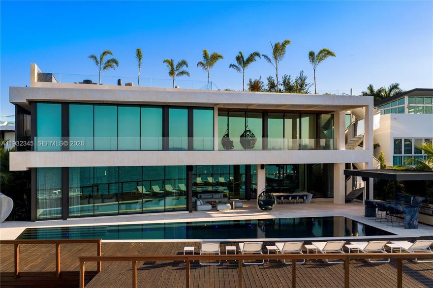One of the most exceptional waterfront residences in Miami. This striking architectural estate offers 10,689 SF of luxurious interior living plus an additional 8,000 SF understory, featuring 7 bedrooms, 7.5 bathrooms, 12-foot ceilings, and expansive open living and entertaining spaces wrapped in walls of glass.

An elevated waterfront terrace opens to a dramatic 70ft knife-edge pool and spa, summer kitchen, and extended deck with sweeping open bay and downtown skyline views, all set behind a rare 14-foot seawall. The home includes dual kitchens (display and staff), a state-of-the-art theater, private elevator, rooftop deck, and an innovative understory accommodating up to 10 vehicles.

High-end finishes include Boffi kitchens and baths, Apure and Lumifer lighting, Ornare closets, and more. Situated on a 13,382-SF lot with 103 feet of prime waterfrontage, the property also features a new deep-water dock for a large yacht and a 30,000-lb boat lift.