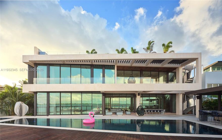 One of the most exceptional waterfront residences in Miami. This striking architectural estate offers 10,689 SF of luxurious interior living plus an additional 8,000 SF understory, featuring 7 bedrooms, 7.5 bathrooms, 12-foot ceilings, and expansive open living and entertaining spaces wrapped in walls of glass.

An elevated waterfront terrace opens to a dramatic 70ft knife-edge pool and spa, summer kitchen, and extended deck with sweeping open bay and downtown skyline views, all set behind a rare 14-foot seawall. The home includes dual kitchens (display and staff), a state-of-the-art theater, private elevator, rooftop deck, and an innovative understory accommodating up to 10 vehicles.

High-end finishes include Boffi kitchens and baths, Apure and Lumifer lighting, Ornare closets, and more. Situated on a 13,382-SF lot with 105 feet of prime waterfrontage, the property also features a new deep-water dock for a large yacht and a 50,000-lb boat lift.