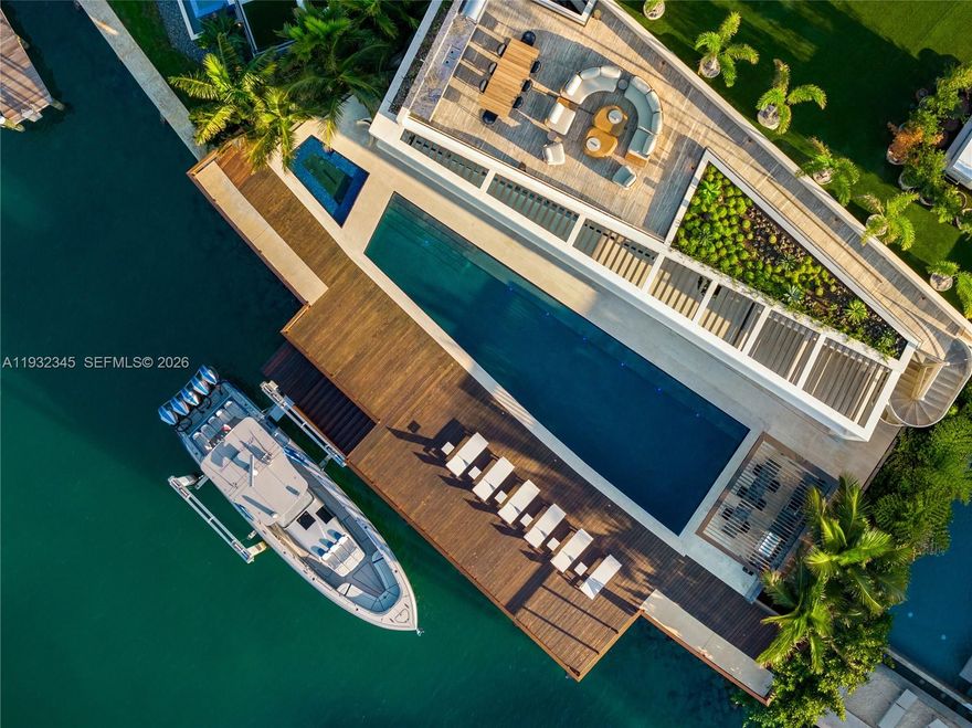 One of the most exceptional waterfront residences in Miami. This striking architectural estate offers 10,689 SF of luxurious interior living plus an additional 8,000 SF understory, featuring 7 bedrooms, 7.5 bathrooms, 12-foot ceilings, and expansive open living and entertaining spaces wrapped in walls of glass.

An elevated waterfront terrace opens to a dramatic 70ft knife-edge pool and spa, summer kitchen, and extended deck with sweeping open bay and downtown skyline views, all set behind a rare 14-foot seawall. The home includes dual kitchens (display and staff), a state-of-the-art theater, private elevator, rooftop deck, and an innovative understory accommodating up to 10 vehicles.

High-end finishes include Boffi kitchens and baths, Apure and Lumifer lighting, Ornare closets, and more. Situated on a 13,382-SF lot with 105 feet of prime waterfrontage, the property also features a new deep-water dock for a large yacht and a 50,000-lb boat lift.