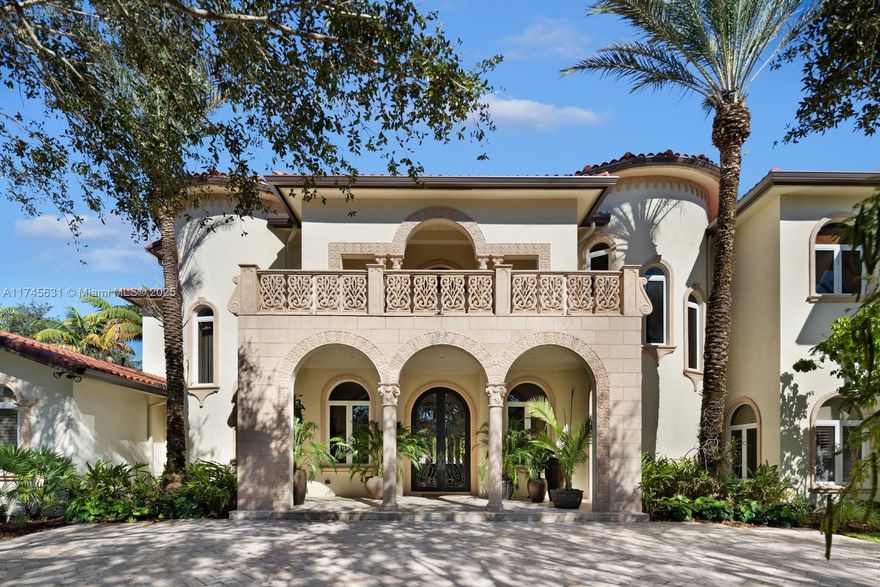 Discover luxury living in this custom-built Mediterranean inspired estate on a gated acre. This 6-bed, 7.5-bath home boasts 8,200+ sq. ft. of modern elegance including a great room with 24-ft ceilings, gas fireplace, formal dining room, and a Mia Cucina kitchen with Wolf, SubZero, and Miele appliances. Two main-floor primary suites offer spa baths, walk-in closets, and French doors to the pool. Upstairs find spacious guest suites, an office, and a state of the art home theater. The backyard oasis features a heated pool, spa, custom outdoor kitchen, and sound system. A separate guest house includes a sauna and cabana bath. With a NEW ROOF, impact glass, generator, security system, new elevator, designer lighting, a 3-car garage and room for a Padel court, this turn-key home is a must-see!