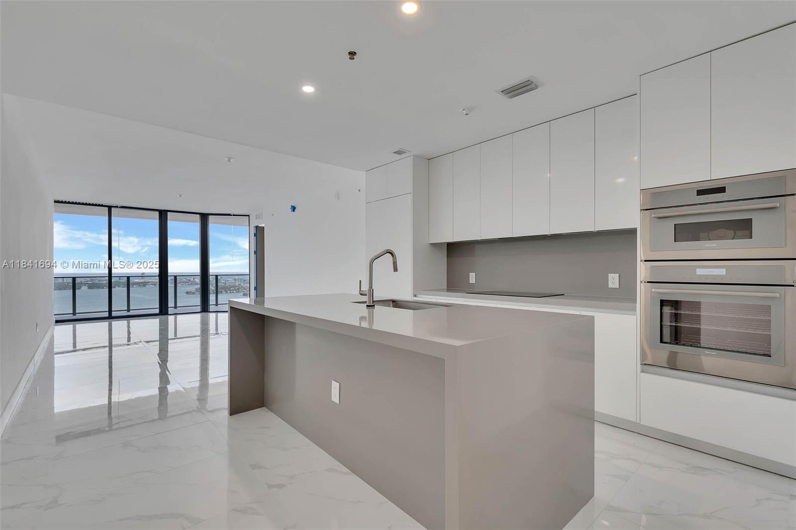Experience the pinnacle of modern luxury at Aria Reserve—Miami’s most anticipated new waterfront address. This brand-new 2025 residence offers three bedrooms plus a den, with meticulously designed interiors and a sprawling terrace showcasing breathtaking 50th-floor views from Biscayne Bay to the Atlantic. The open layout is anchored by a sleek gourmet kitchen with top-of-the-line appliances and upgraded engineered stone countertops. Additional upgrades include a dropped ceiling in the living/dining room and primary suite, trimless lighting, frameless doors, elegant window treatment. This home includes two adjacent parking spaces—a rare and valuable convenience.