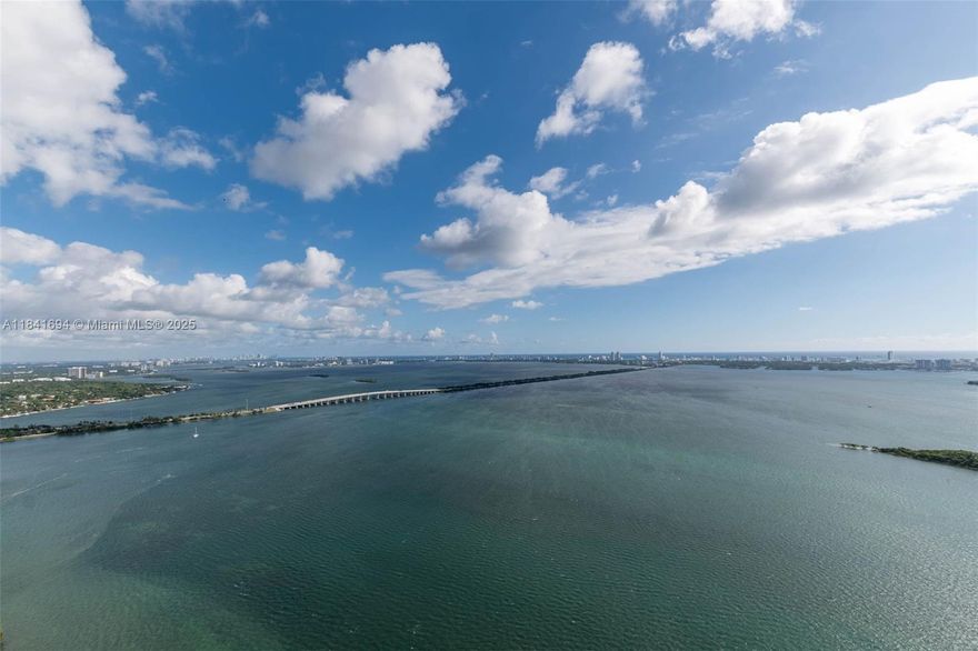 Experience the pinnacle of modern luxury at Aria Reserve—Miami’s most anticipated new waterfront address. This brand-new 2025 residence offers three bedrooms plus a den, with meticulously designed interiors and a sprawling terrace showcasing breathtaking 50th-floor views from Biscayne Bay to the Atlantic. The open layout is anchored by a sleek gourmet kitchen with top-of-the-line appliances and upgraded engineered stone countertops. Additional upgrades include a dropped ceiling in the living/dining room and primary suite, trimless lighting, frameless doors, elegant window treatment. This home includes two adjacent parking spaces—a rare and valuable convenience. Please look at attachments for a complete description of all upgrades.