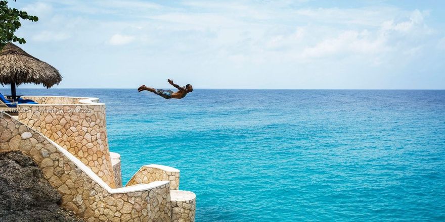 The Caves is a globally recognized oceanfront boutique hotel perched atop limestone sea caves beside the historic Negril Lighthouse. Part of Chris Blackwell’s Island Outpost Collection, this 13.12-acre sanctuary spans both sides of Lighthouse Road—connected by a pedestrian tunnel—and offers a rare blend of natural beauty, iconic brand equity, and development potential. The oceanside parcel includes 11 guest cottages (13 beds), spa, pool, Blackwell Rum Bar, rooftop and cave dining, kayaking, cliff jumping, and more. The landside includes a 4BR private villa with pool and land approved for 20+ additional cottages and 17 villa lots. Approx. 3,813 SF interior. A one-of-a-kind opportunity for boutique hoteliers or visionary investors. Can be purchased with sister property Strawberry Hill.