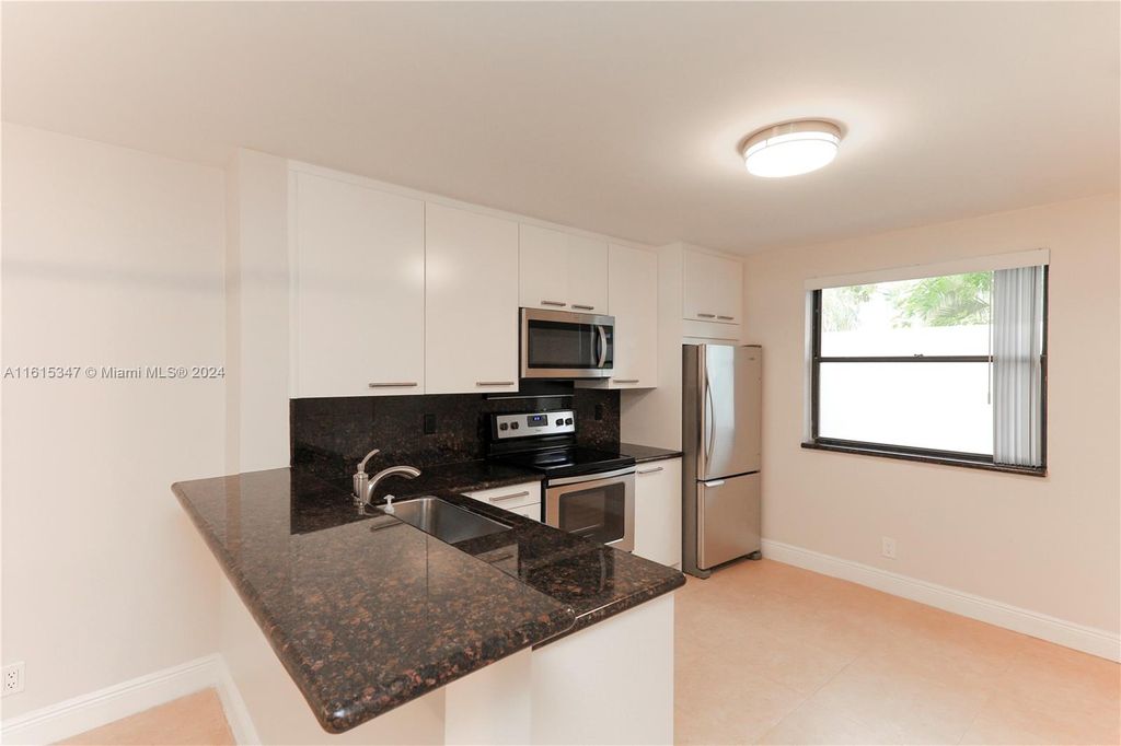 Photo of 10125 W Sunrise Blvd #101, Plantation, FL 33322 (MLS # A11615347)