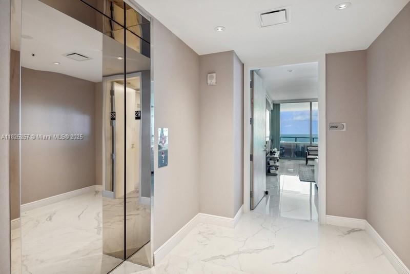 Welcome to Unit 2902 a flow-through, oceanfront luxury retreat on the 29th floor with stunning direct Atlantic and intracoastal views. Featuring 3 bedrooms with full en-suite bathrooms and a powder room for guests. The spacious 2,137 sq. ft. of elegant living space with marble flooring is complemented by two balconies: one ocean-facing terrace for sunrise views and another overlooking the city skyline for sunsets, totaling approximately 325 sq. ft. Floor to ceiling windows and private elevator lobby, Italian cabinetry, stone countertops with Gaggenau appliances. Prime beachfront living within minutes of Aventura Mall and Bal Harbour Shops, and 30 minutes to MIA or FLL airports.