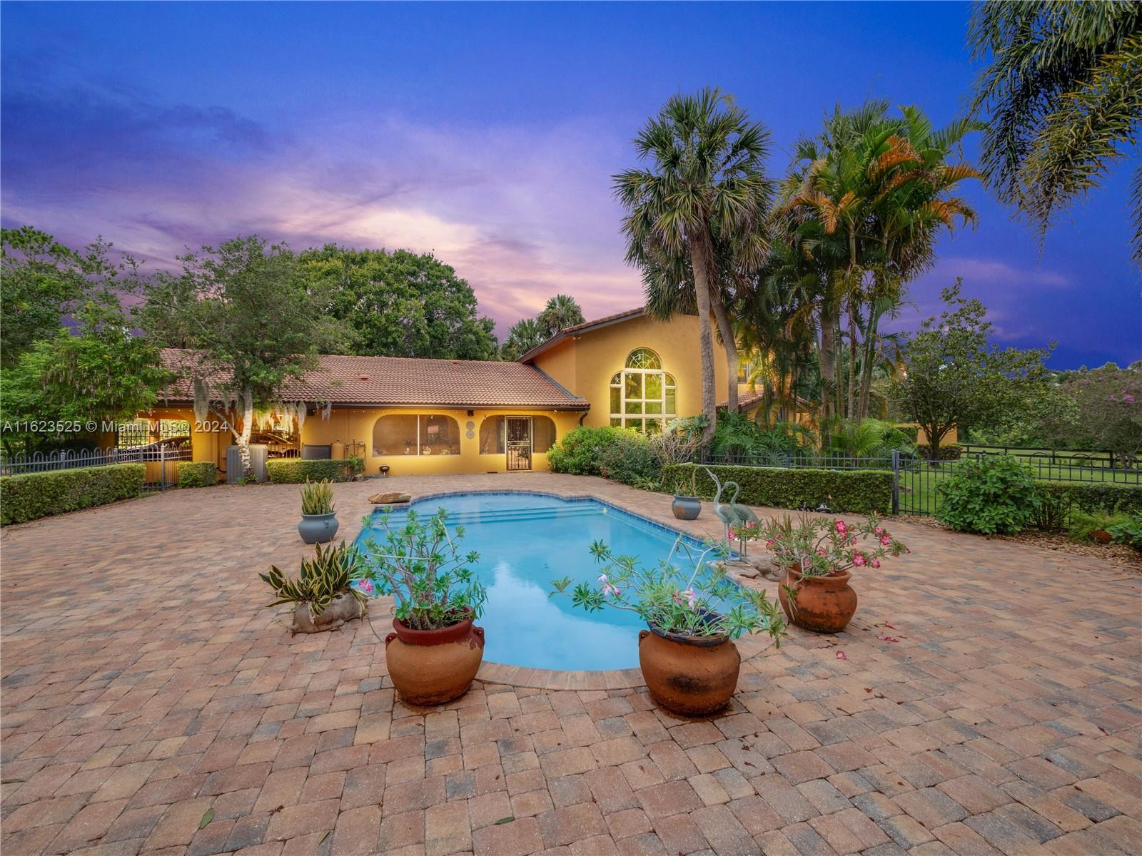 JUST REDUCED!! Welcome to your dream home-nestled in 5 picturesque acres. Exquisite 2-story residence offers unparalleled blend of luxury, comfort & equestrian amenities. Lush foliage & expansive paver deck surrounds saltwater pool for relaxation & summer fun! 5BR/3BA home is perfect for entertaining-weddings & fundraisers held on these grounds w/175+ people. Barn w/2 stables, tack rm, workshop, A/C storage rm & 4 acres of pastures. Large eat-in kitchen w/granite counters, wine fridge, formal dining rm, living rm w/tall ceilings, stunning window & wood burning fireplace. Primary Suite w/garden access, dual sinks, separate tub & shower, huge walk-in closet. Welcome Home to this rare find offers an idyllic country lifestyle w/modern comforts-only 4 miles from town-less than 1 hour to beaches
