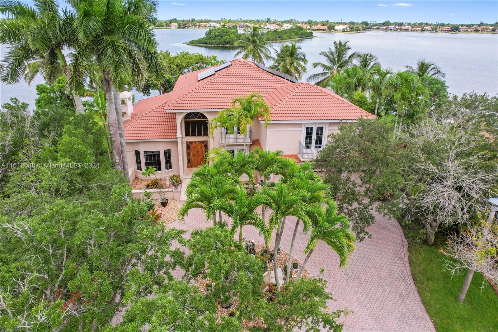 This one-of-a-kind gem is located amongst 39 custom homes in the exclusive Sunset Isles in Silver Lakes. Owner built the home to take advantage of the approx 183ft of lakefront offering breathtaking views of the water, sunrises and sunsets. Features 3 bed, 4.5 bath, office, formal living and dining, family room, kitchen, kitchen dining, oversized pool. 3 car garage and large circular driveway  for up to 11 vehicles. Vaulted ceilings, Spanish tile, hardwood floors, wooden staircase, fireplace, wood kitchen cabinetry, granite countertops, SS appliances, custom built-ins and more adorn the interior of this unique home. Roof and solar panels 2019, impact insulated windows 2013.  The 18,000+ ft lot and over 3,600 of living space offer a new owner the possibility to create their custom home.