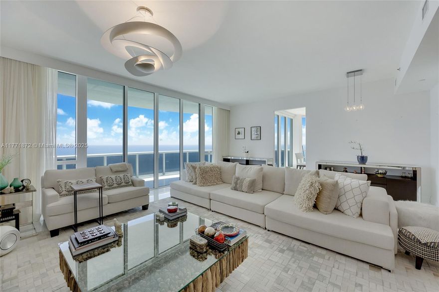 Step into a world of elegance and tranquility in this breathtaking 3-bedroom, 3.5-bath residence, where unobstructed, panoramic ocean views create an unparalleled coastal retreat. With soaring high ceilings and floor-to-ceiling windows, every space is bathed in natural light, enhancing the sense of openness and sophistication. The wraparound terrace invites you to wake up to golden sunrises, sip your morning coffee with a gentle sea breeze, or unwind with evening cocktails while gazing at the endless horizon. The gourmet kitchen boasts premium finishes, while the spa-inspired master suite offers the ultimate in relaxation. Indulge in world-class amenities, including private beach access, a state-of-the-art fitness center, full-service spa, infinity-edge pool, and 5-star concierge service.