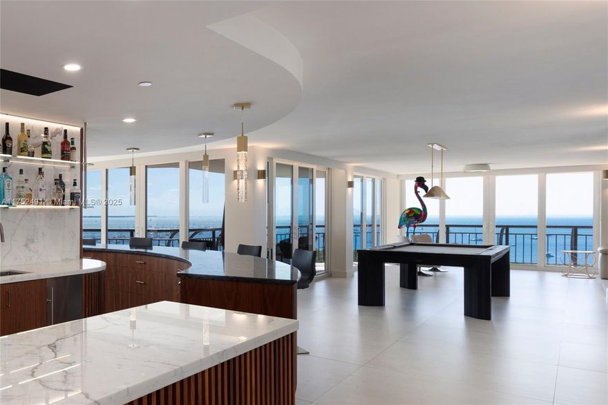 A modern haven in the sky with the most PRICELESS views in all of Coconut Grove. The 180 degrees of glass let you take in sparkling Biscayne Bay, Downtown, and Key Biscayne from every angle. With generous and thoughtful entertaining spaces including a chef’s kitchen with full bar and seating, wraparound balconies, dining room with video wall, and game area, your guests will be dazzled by more than just the vistas. Enjoy unparalleled walkability to the center Coconut Grove and its dining and shopping. Amenities come up to you with private gym, sauna, steam room, and jacuzzi. When you’re ready for relaxation, retreat to a primary suite with two walk-in closets and striking stone wet room with freestanding tub and double shower. Large in-unit storage room plus six assigned parking spaces.