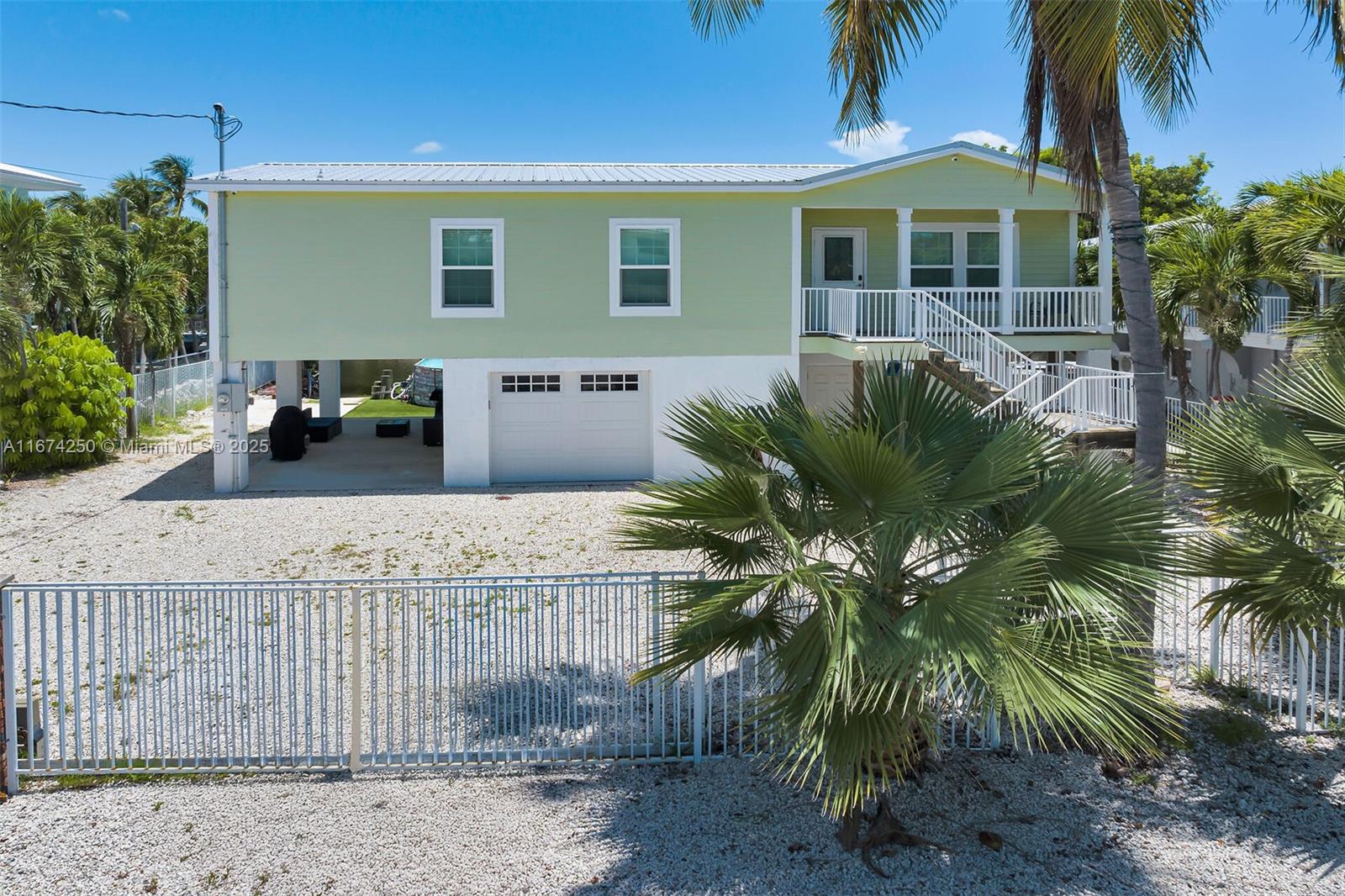 Discover the ultimate waterfront retreat in the heart of Islamorada, in the highly sought after neighborhood of White Marlin Beach. This captivating 3-bedroom, 2-bathroom gem is a dream come true. The interior features an open floor plan with 9-foot ceilings and ceramic tile. Embrace the coastal lifestyle with stunning water views right from your backyard and revel in the convenience of a private boat ramp and dock. Take a short trip just a couple blocks away to your private homeowner's park with sandy beach. Safety and security are paramount, thanks to the fully fenced yard with electric sliding gate and impact windows and doors. The one-car garage, carport and shop provide space for multiple vehicles and hobby projects.