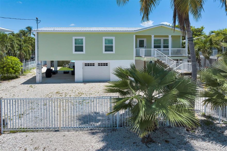 Discover the ultimate waterfront retreat in the heart of Islamorada, in the highly sought after neighborhood of White Marlin Beach. This captivating 3-bedroom, 2-bathroom gem is a dream come true. The interior features an open floor plan with 9-foot ceilings and ceramic tile. Embrace the coastal lifestyle with stunning water views right from your backyard and revel in the convenience of a private boat ramp and dock. Take a short trip just a couple blocks away to your private homeowner's park with sandy beach. Safety and security are paramount, thanks to the fully fenced yard with electric sliding gate and impact windows and doors. The one-car garage, carport and shop provide space for multiple vehicles and hobby projects.