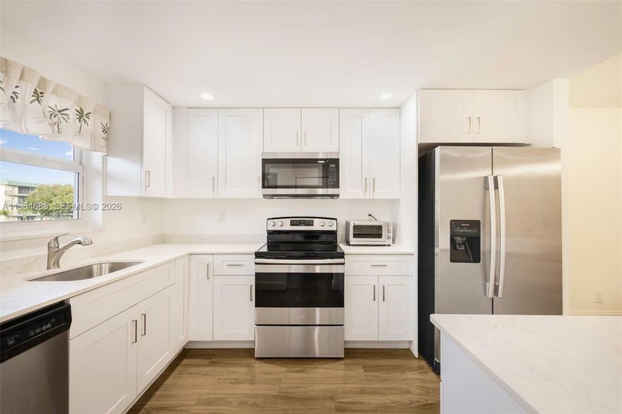 Completely renovated and impeccably maintained, this 2-bedroom, 2-bath residence offers elevated coastal living less than one mile from Deerfield Beach and within easy reach of local shops, dining, and everyday conveniences. The thoughtfully redesigned interior features a sleek modern kitchen with a center island, contemporary cabinetry, and updated appliances, seamlessly connecting to bright, open living spaces. Complete impact windows and doors provide peace of mind while enhancing natural light throughout. Both bathrooms have been beautifully updated with clean, modern finishes. Furnishings less than one year old are available for purchase, offering a turnkey opportunity. Situated in a well-maintained community with desirable amenities and no current or anticipated assessments, this home presents a compelling opportunity in a prime location.