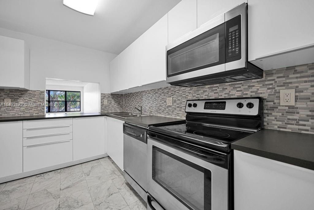 Photo of 2300 S Cypress Bend Dr #201, Pompano Beach, FL 33069 (MLS # A11493172)