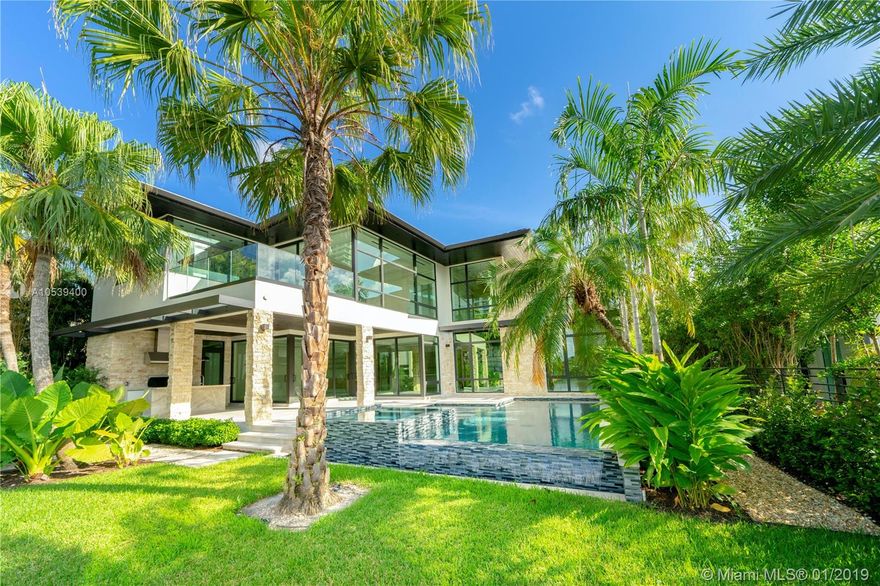 Be the first to live in this brand-new chic contemporary waterfront home w/ 80' of deep wide water frontage. New dock and seawall with no bridges to bay/ocean. Beautifully designed 6 bed/6 full baths/2 half baths w/ high-end finishes, summer kitchen by pool & water, dramatic 28ft.ceiling in great rm, imported Italian open kitchen w/ sleek stainless-steel Wolf appliances, MIA Cucina custom cabinetry, wide plank marble flooring, glass railing w/ Wenge wood staircase, wine rm. A perfect floorplan for family living/entertaining. Smashing master bedrm w/ huge custom closet & spa-like bathrm w/ walk-in rain shower & soaking tub. 4bedrm suites upstairs, terraces, laundry rm & 2 beds downstairs w/ elevator, office & double height garage. Lutron home automated lighting system. Stunning Landscaping.