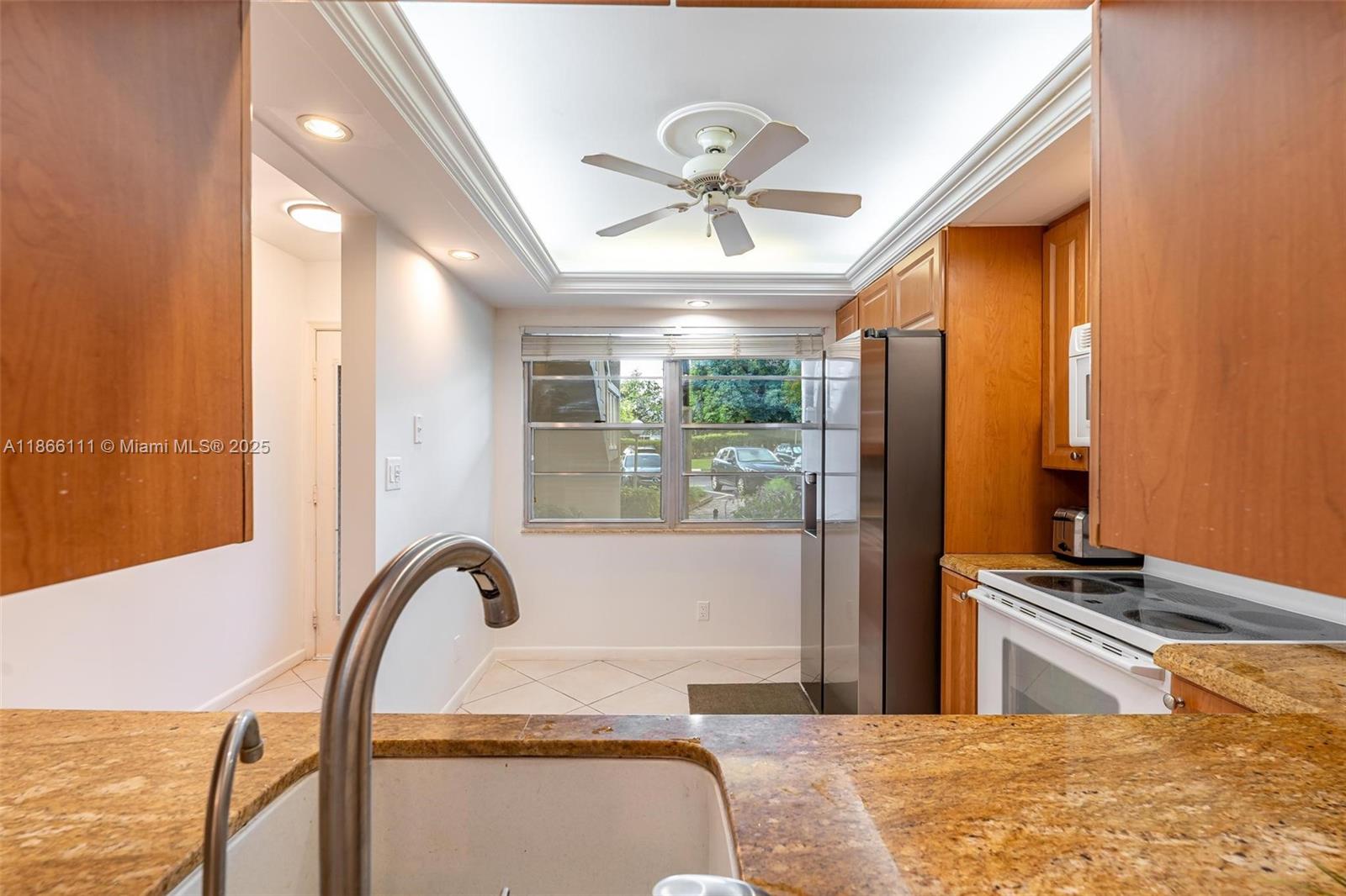 Welcome to this charming 2-bedroom, 2-bathroom condominium offering comfort and convenience in the vibrant and active adult community of Wynmoor. It offers a variety of amenities, including a clubhouse, theater, pool, fitness center, pickleball, tennis, live music, a movie theater, clubs, an art studio, a barbecue area, and free bus transportation for easy access to shopping and errands. The Wynmoor Theater is a short walk away. The condominium boasts magnificent views of the golf course and water, perfect for enjoying morning coffee on your private patio. Shared laundry facilities are available. The kitchen is a chef's delight, with beautiful granite countertops, while the bathrooms are elegantly renovated with modern vanities featuring granite surfaces. SELLER IS MOTIVATED!!!