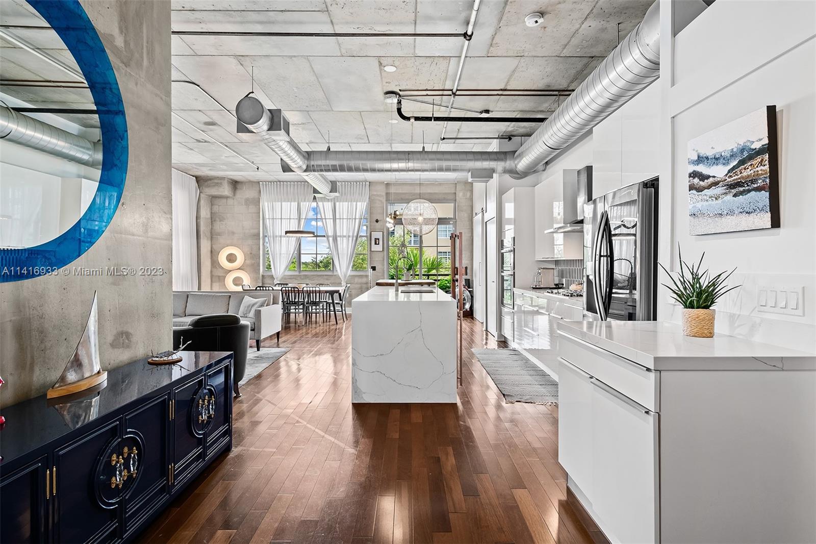 Welcome to Mill Lofts! Unit 301 is the ultimate corner loft equipped with oversized windows, dramatic 11 ft ceilings, warm wood floors, and a newly remodeled designer kitchen. The unit features an expansive balcony, two enclosed ensuite bedrooms, custom window accents, built-in closets, and artfully selected fixtures. This New York inspired loft built by local developer Hooper Construction, was the defining project that ignited a booming Arts District in Fort Lauderdale. Flagler Village is a walkable community offering mixed use live/work spaces, both creative and traditional. The Mill Lofts invokes both modern & industrial design elements while incorporating lifestyle amenities such as south facing pool & secured parking.