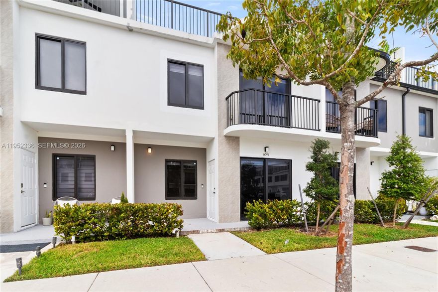 Be the first to occupy this stunning 4-bedroom, 3-bath townhome. This concrete-built home features impact windows, a private rooftop terrace, and two dedicated parking spaces. Inside, enjoy modern finishes including quartz countertops and an open-concept kitchen equipped with stainless steel appliances. The primary suite offers a full bathroom, walk-in closet. A versatile flex room on the ground floor includes a closet and full bath — perfect as a bedroom, home office, or in-law suite.