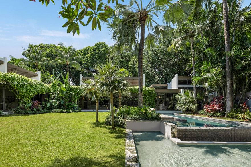 Stunning mid-century modern masterpiece awaits on exclusive Saint Gaudens Road! This 2023 ground-up rebuild by renowned Farache Bromberg Design Studio sits on a magnificent half-acre corner lot with lush landscaping by Raymond Jungles. Five bedrooms and five and a half bathrooms span over 5,000 square feet of sophisticated single-story living. High ceilings and beautiful skylights create an airy ambiance throughout. Top-tier finishes elevate every detail. The outdoor summer kitchen and cabana bath extend entertaining possibilities while an oversized swimming pool and massive backyard offer a serene setting for endless family enjoyment. The Property includes over 5,000 SF of additional land that is not included in tax rolls bringing the total lot size to approximately 25,000 SF.