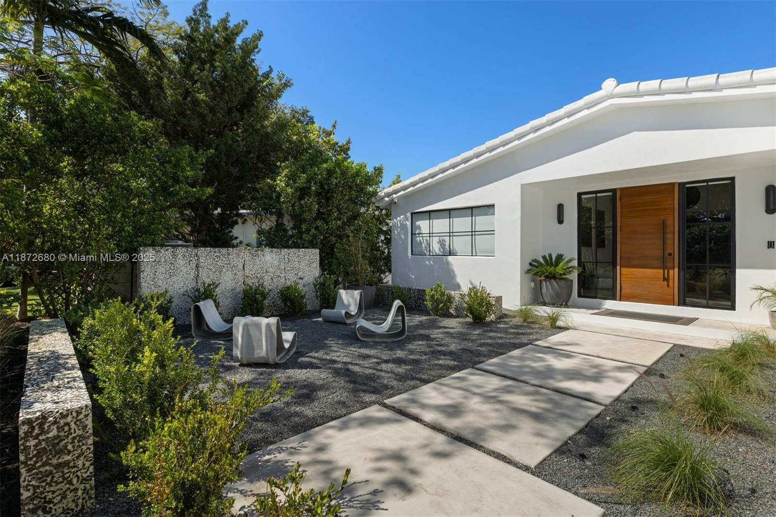 Beautifully rebuilt Mid-Century Modern home in Surfside. The home has 4 bedrooms, 3 bathrooms, an outdoor dining area, open floor plan, tons of natural light and a new pool that both heats and cools. The open kitchen is perfect for entertaining with a large center island, custom cabinetry, quartz countertops, a 36" gas Dacor range, wine fridge and beverage center. The home has wide plank wood floors, a walk-in closet in the primary bedroom and cat 5 internet throughout with 4 cameras hardwired around the property. Thoughtfully landscaped and hardscaped, this home allows you to enjoy the best of Surfside indoor and outdoor living. Walking distance to the beach, shops and restaurants and area playgrounds.