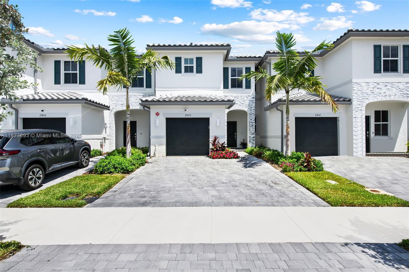 Welcome to 11853 Northwest 47th Manor, Coral Springs—not your average new construction in Sunset Trails in Coral Springs. An elegant & modern 3-bedroom, 2.5-bathroom home spanning 1,434 sq. ft. Revel in the open living spaces, custom closets, & motorized silhouette shades. The fully custom kitchen boasts a high-end Fisher & Paykel fridge, ample cabinetry, & waterfall countertops. Entertain your guests in your private backyard, including high-end sandblasted marble pavers & artificial turf. Enjoy the secured community amenities including a playground, pool, clubhouse, & gated community entry. Complete with an epoxy spacious garage, wired with cameras. This home offers both comfort & style. A+ schools, close to malls, highways, & parks. BEDROOMS HAVE BEEN PAINTED WHITE!