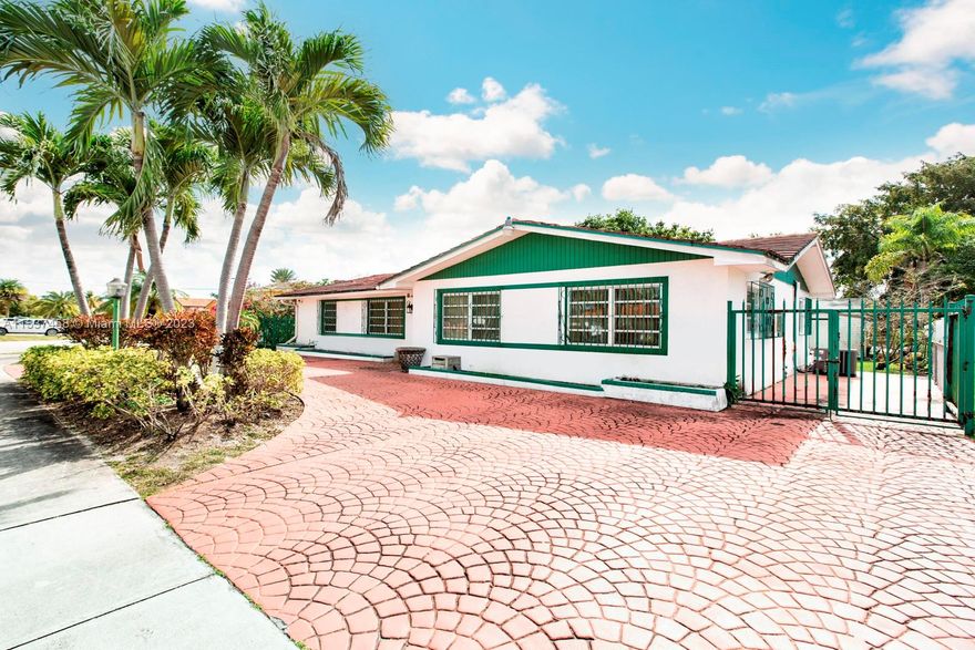 This large corner house in the University Park area by FIU is made up of two sections, a 3/2 and a 1/1, each with separate entrances, and each section with its own kitchen. The main section features an open concept layout with large living areas and a kitchen with an eat-in, marble countertop. The house itself features a large circular driveway, a metal perimeter fence, and a huge backyard with multiple patio areas. Perfect for multi-generational families and students.