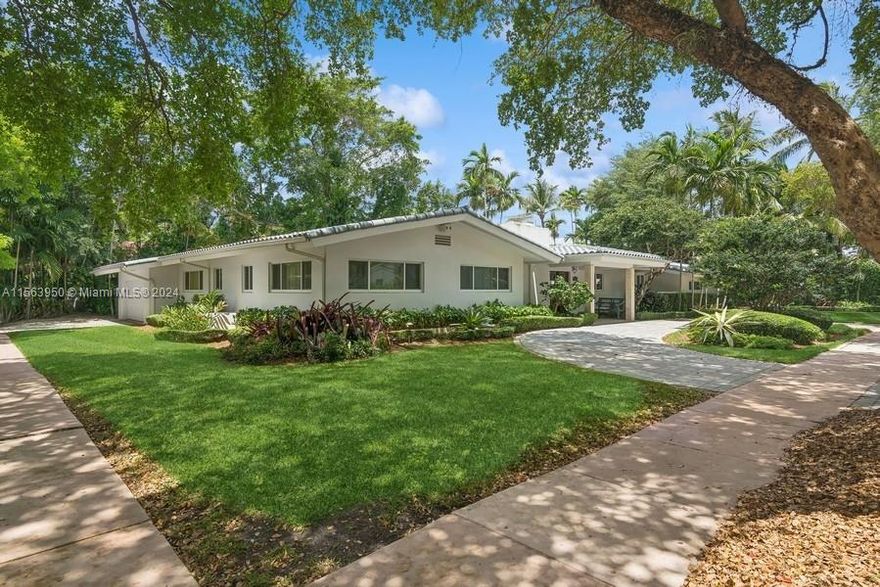 Spectacular North Gables Tropical Oasis! This spacious 3,375 sqft, 1-story 3bd/3bths + wood-paneled study, offers a perfect blend of classical elegance and modern updates. Nestled on a 16,800 sqft corner lot, the covered entry leads into a lg formal living & formal dining, which opens to an extra-lg covered terrace, exuding breathtaking views of the exquisite, lush backyard, open pool area & summer kitchen! Ideal for alfresco dining and entertaining! The serene primary suite, boasts double walk-in closets, a bathroom w/separate sinks, makeup vanity and lg shower. The gourmet kitchen is a chef's dream, featuring all wood & granite finishes. A spacious family rm w/wet bar,also opens to the pool area. Steps away from Country Club Prado & excellent Schools! Truly Florida living at its finest!
