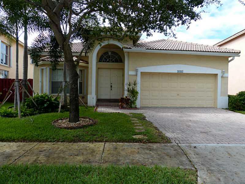 Beautiful home in Emerald Estates with fantastic lake view in a man guarded community. Tile and wood throughout. Wood kitchen cabinets with granite and stainless steel appliances. Remodeled bathrooms. Laundry inside the home. Best schools of Weston. Close to shopping and easy highway access