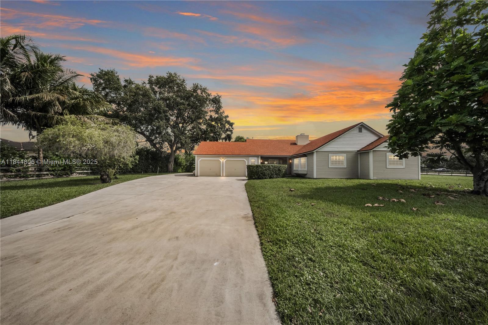 Nestled in the heart of Davie on an oversized, canal-front corner lot, this exceptional property offers the perfect blend of rustic charm & modern convenience, all with the benefit of NO HOA. Bring your horses to this fantastic home! Inside, wood laminate floors, anchored by a double-sided wood-burning fireplace. The home boasts significant recent upgrades, including a new A/C unit installed in 2023 & a new roof installed in 2022. The primary bathroom underwent a complete, luxurious renovation in 2024. Enjoy seamless indoor-outdoor living with impact-resistant sliding patio doors in both the living room and primary suite. The exterior features an assortment of mature fruit trees, a charming chickee hut with a newly thatched roof, a refreshing pool with a waterfall, & a separate Jacuzzi.