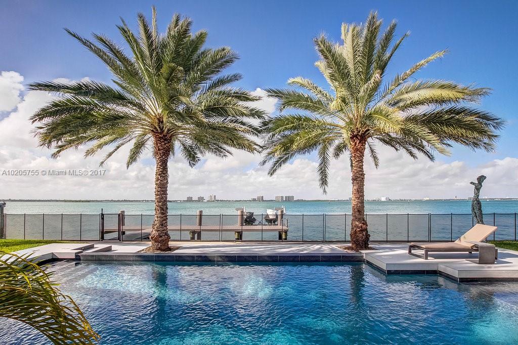 Unobstructed wide bay views offering 95 feet of waterfront on 16318 sq ft lot in a gated and secure Miami Beach community. This spectacular mid-century modern home features an open living area, spacious rooms.The oversized gourmet kitchen is outfitted with high end appliances .Marble bath & wood floors. Dock with boat slip, huge pool overlooking the Water.
