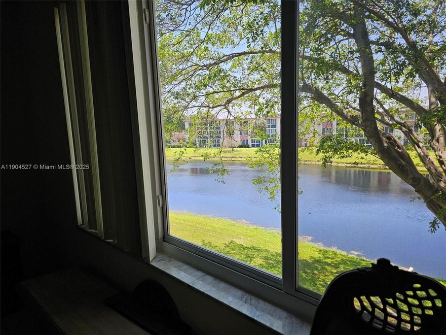 Take in the breathtaking Lake view as you enter this Modernized 2/2 55+ Condo on 3rd floor. Move in ready to enjoy the tranquil lake view from living room, primary & balcony. Eat in kitchen, new stove, newly remodeled baths, new water heater, 2024 AC, glassed in balcony/sunroom to relax enjoying stunning sunsets. Tile floors, newly carpeted bedrooms, impact windows, LOW $372 per month maintenance. Well maintained building, management company. Laundry facilities & storage on floor, tennis, shuffleboard, pool, gym, community room, BBQ, picnic area, trash chute, 1 assigned parking spot, international neighbors, close to shopping.