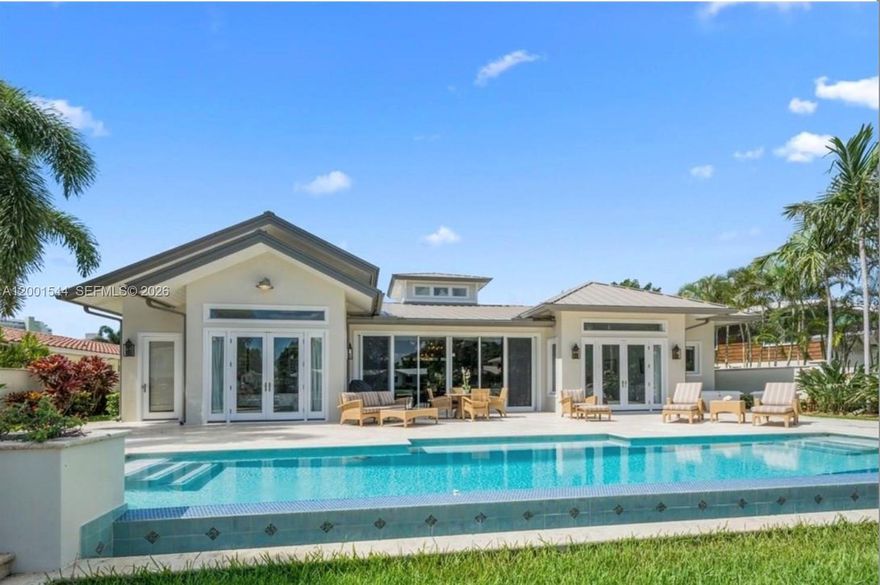 Nestled within the exclusive enclave of Harbor Beach, this exquisite 3-bedroom, 3.5-bath Mediterranean-inspired residence offers the perfect blend of timeless architecture and effortless South Florida living. Set along a deepwater canal with 80 feet of prime dockage and a 10,000 lb boat lift, this home is a rare opportunity for boating enthusiasts seeking immediate ocean access with no fixed bridges.

From the moment you arrive, the home’s classic Mediterranean design—arched entryways, warm stucco finishes, and refined detailing—creates an atmosphere of understated luxury. Inside, sun-drenched living spaces flow seamlessly, featuring spacious entertaining areas, elegant finishes, and serene water views that bring the outdoors in.

The well-appointed kitchen opens to the main living areas, ideal for both intimate gatherings and sophisticated entertaining. Each of the three bedrooms offers en-suite privacy, while the primary suite serves as a tranquil retreat with generous proportions and a spa-inspired bath. Step outside to your private waterfront oasis,beautifully designed patio invites al fresco dining, lounging, and sunset cocktails. Whether you're setting out for a day on the water or enjoying the peaceful canal setting, this home embodies the essence of the Harbor Beach lifestyle.Located just moments from Fort Lauderdale’s finest beaches, dining, and yachting destinations, and within one of the city’s most sought-after communities