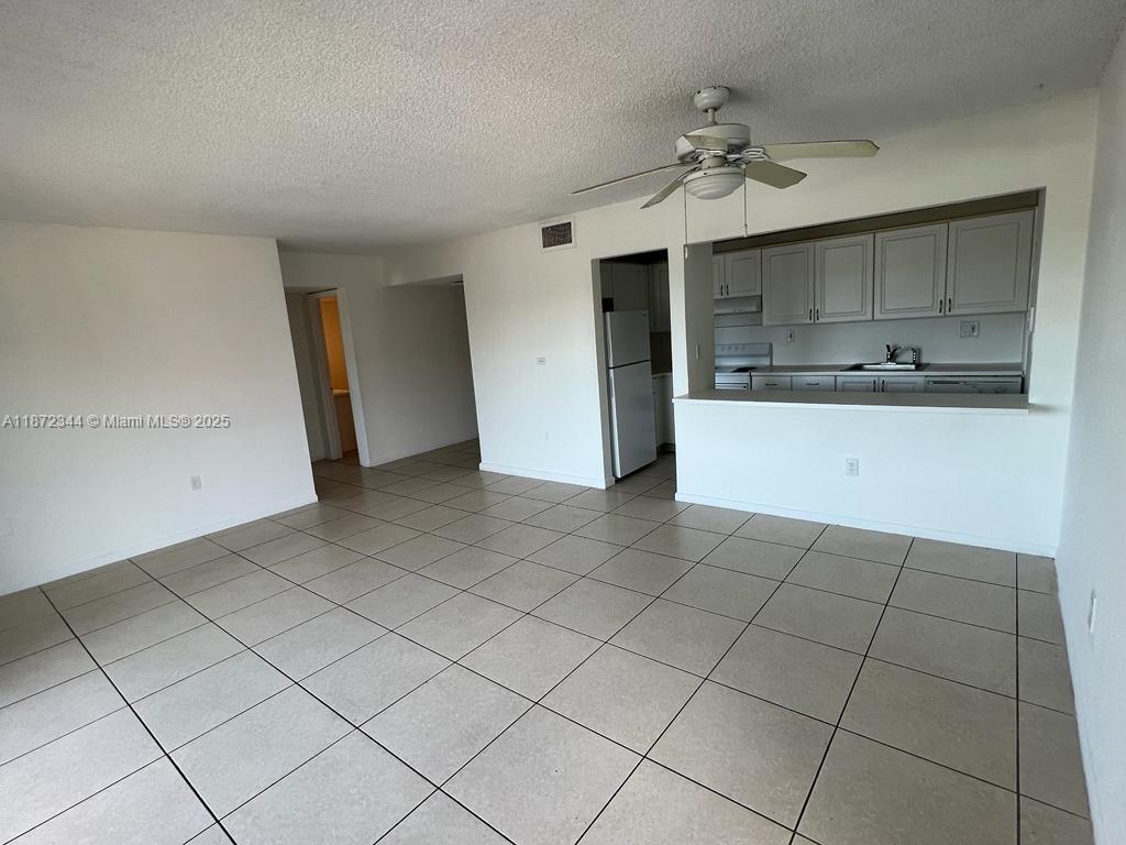 Spacious and cozy 1-bedroom, 1-bathroom unit featuring tile flooring throughout the living areas and laminate flooring in the bedroom. Enjoy ample closet space and a large balcony perfect for relaxation. Conveniently located with easy access to the Palmetto Expressway.