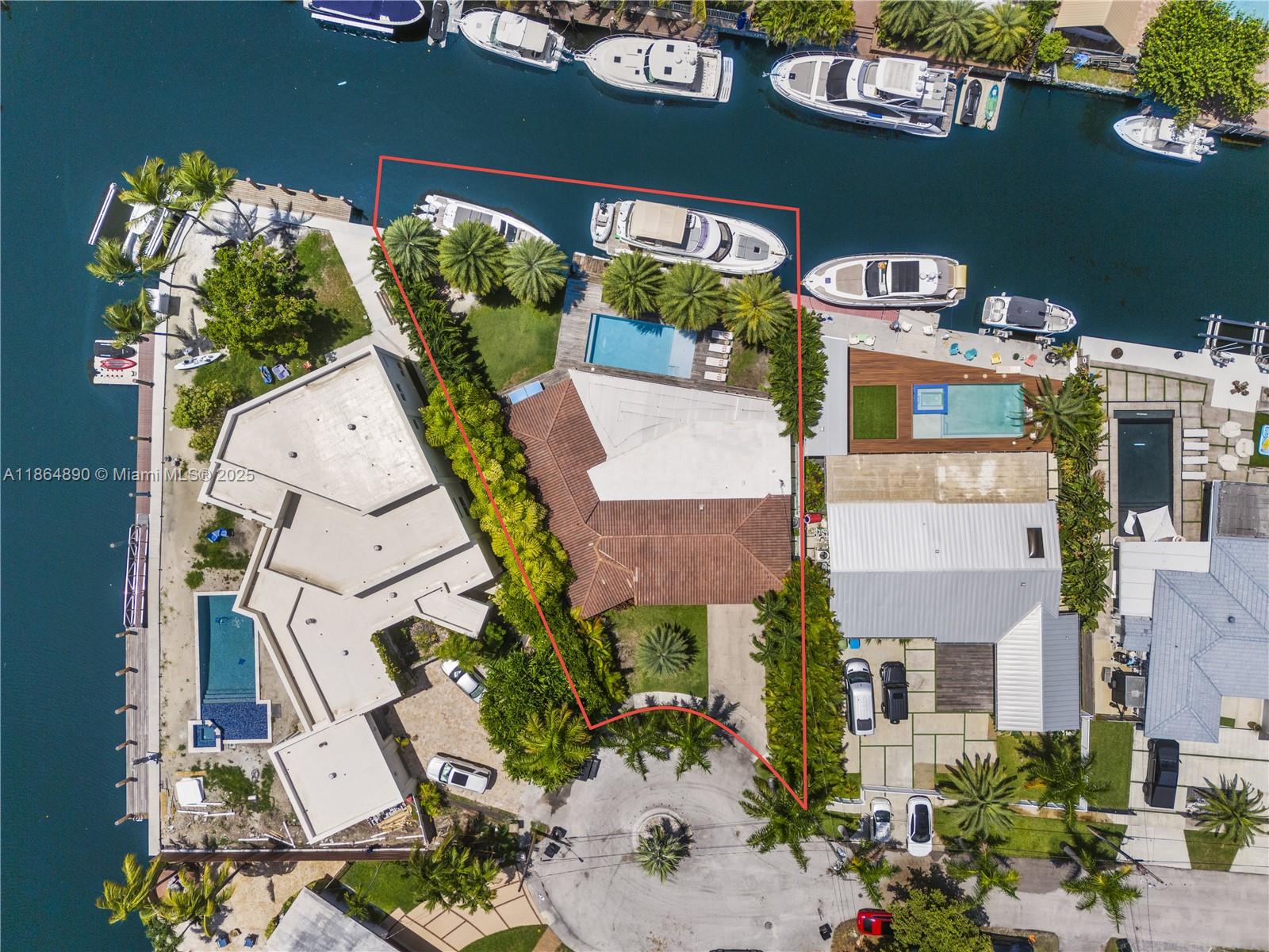 Boater’s Dream Home ideally located in gated Keystone Islands in North Miami offering 115 ft of water frontage, private dock and NO FIXED BRIDGES for direct access to Biscayne Bay. Situated on a 10,161-sq-ft lot, this updated mid-century modern 3-bedroom, 2-bathroom pool home features an open layout, 24x24 Spanish porcelain tile throughout, impact windows and a modern eat-in kitchen with oversized Chef’s island and top-of-the-line appliances including 2 Bertazzoni refrigerators and range. The backyard is perfect for entertaining boasting an expansive covered patio, summer kitchen, outdoor living/dining, heated salt-water pool with deck and lounge area and ample grassy space. Completing the home is an air-conditioned 2-car garage currently utilized as a home office.
