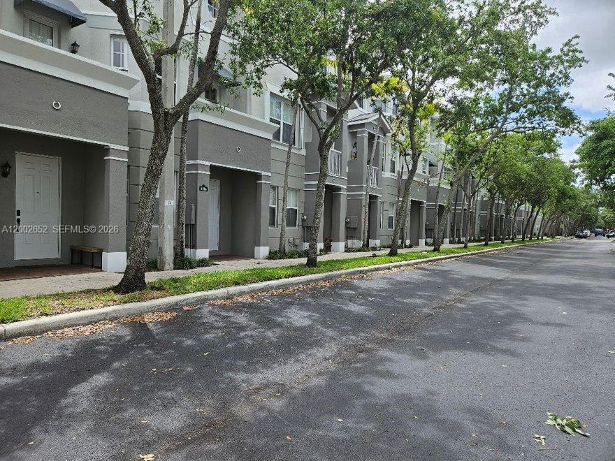 This beautiful town home is located in a gated community. This home is very spaciously laid out with three bedrooms and four bathrooms. First floor has attached garage with full size washer & dryer and a bedroom with a full bath. Second floor includes eat in kitchen, dining area, living Room, half bath and a private outside balcony. Kitchen has two pantry's and an Island for prep. Third flood includes two bedrooms with two full baths. There is tile and wood flooring throughout home except stairways. This property is also centrally located close to schools and a wide variety of restaurants & shopping. Community offers pool and fitness center.  Pets are welcome here.